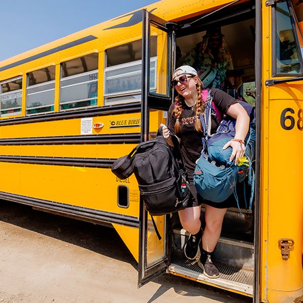 Attendee getting off bus