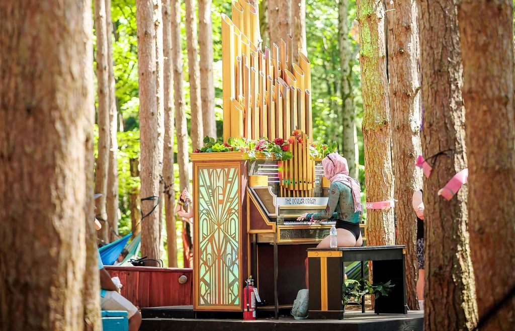 Attendee playing piano in the forest